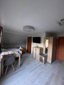 a room with a bed and a table and a television at SUN & WINE in Pobierowo +35 photos