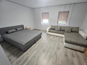 a bedroom with a bed and a couch at Dream vendégház in Vásárosnamény