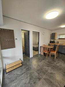a living room with a table and a kitchen at Dream vendégház in Vásárosnamény