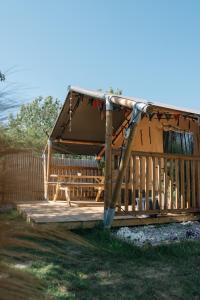 a wooden gazebo with a swing at SoulSafari aan Zee in Julianadorp