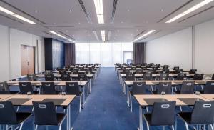 a large room with tables and chairs in it at IntercityHotel Frankfurt Airport Terminal 3 in Frankfurt