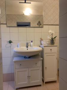 a bathroom with a sink and a mirror at La Canonica Di San Michele in Monteriggioni +87 photos