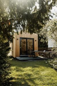 a wooden building with a table and chairs in a yard at Tiny Chalet in Blankenburg