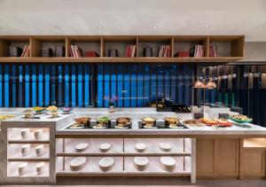 a buffet with many different types of food on display at Manxin Hotel Beijing Lama Temple in Beijing +33 photos