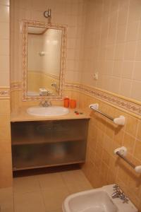 a bathroom with a sink and a mirror at Casa de Tapadeiro in Resende