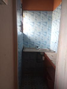 a bathroom with a sink and a blue tiled wall at Geobajas Hotels in Imushin +27 photos