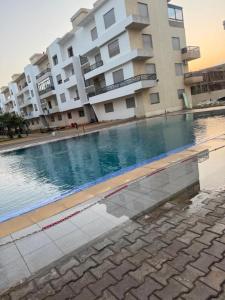 a large swimming pool in front of a building at البحر والشمس والطبيعه in Pont Blondin +19 photos