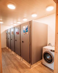 a row of lockers in a bathroom with a washing machine at SoulSafari aan Zee in Julianadorp