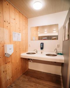 a bathroom with two sinks and a mirror at SoulSafari aan Zee in Julianadorp +23 photos