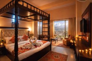 a bedroom with two swans sitting on a bed at Aachman Regency Shimla Mallroad in Jutogh