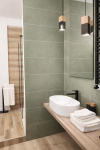 a bathroom with a sink and a mirror at A Due Passi Dalla Scalinata Rooms in Caltagirone +14 photos