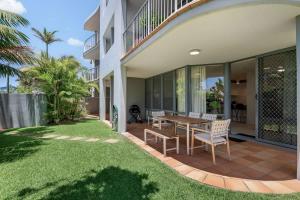 a house with a patio with a table and chairs at Pawfect Coastal - Pet friendly Beachfront Pool in Marcoola
