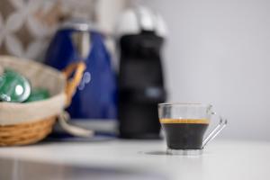 a cup of coffee sitting on top of a counter at Vista mare Fiumicino-Beach&Fly Stay in Fiumicino