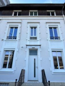 a white house with a white door and windows at Central Grenoble Lovely House in Grenoble