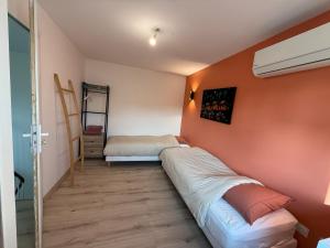 a small room with two beds and a mirror at Central Grenoble Lovely House in Grenoble