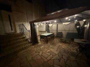 a ping pong table in a building at night at Central Grenoble Lovely House in Grenoble +7 photos