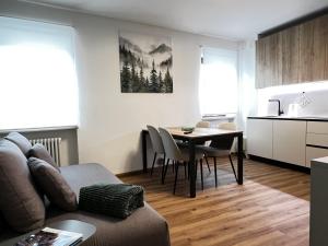 a living room with a couch and a table at Casa Primavera in Agordo