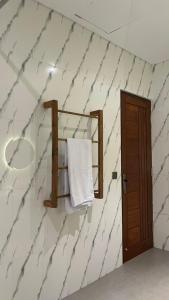 a bathroom with a white towel on a wall at Pondok Wahyu in Ubud