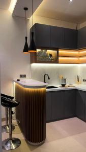 a kitchen with a large wooden bar in the middle at Pondok Wahyu in Ubud +9 photos