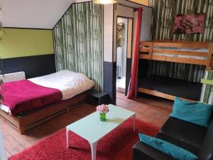 a bedroom with a bed and a table and a couch at Chambre liberté Domaine de la Belle Normandie in Condé-sur-Noireau +31 photos