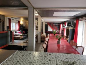 a long dining room table with a red table cloth at Chambre liberté Domaine de la Belle Normandie in Condé-sur-Noireau