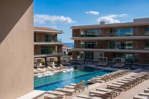 an image of a hotel swimming pool with lounge chairs at Kora Tigot in San Miguel de Abona