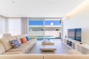 a living room with a couch and a table at Vila Praia Grande in Sines