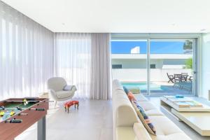 a living room with a couch and a table at Vila Praia Grande in Sines