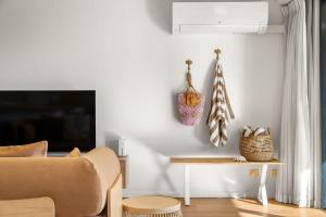 a living room with a couch and a table at Coastal Drift - Beach Access Pool Spa Gym in Marcoola +25 photos