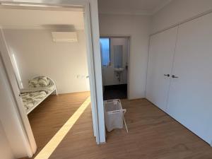 a room with a bedroom with a bed and a mirror at Modern Karnup House in Karnup