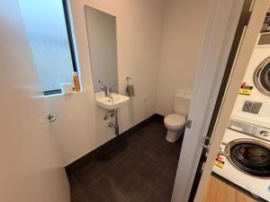a small bathroom with a sink and a toilet at Modern Karnup House in Karnup