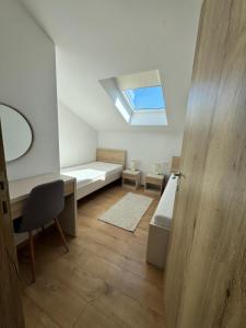 a room with a bed and a desk and a window at Apartman Moonlight Medulin in Medulin