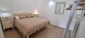 a small bedroom with a bed and a mirror at La Casetta in Monteforte Irpino