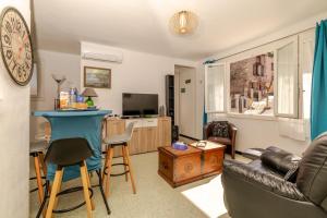 a living room with a couch and a table at Appart cathare et l'olivier in Tautavel