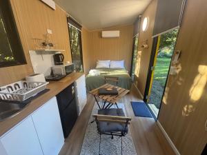 a small kitchen with a bed in a tiny house at The Secret Place by Tiny Away in Palmvale