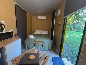a small room with a bed in a tiny house at The Secret Place by Tiny Away in Palmvale +30 photos
