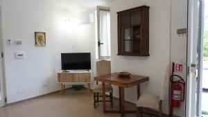 a living room with a table and a television at La Casetta in Monteforte Irpino