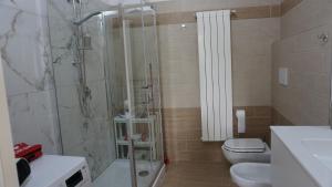 a bathroom with a shower and a toilet and a sink at La Casetta in Monteforte Irpino +15 photos