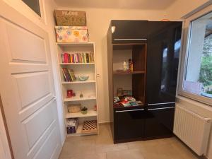 a walk in pantry with a black refrigerator at Rigó Vendégház in Siófok +16 photos
