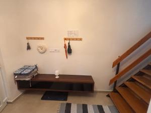 a room with a wooden bench next to a staircase at Rigó Vendégház in Siófok