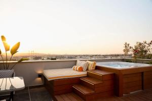 a bath tub sitting on top of a balcony at VELORA - Sodic Penthouse with jacuzzi & big terrace over New Cairo view in New cairo