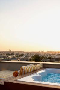 a hot tub on the roof of a building at VELORA - Sodic Penthouse with jacuzzi & big terrace over New Cairo view in New cairo