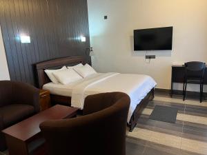 a hotel room with a bed and a flat screen tv at Blooming Rose Ella in Ella +87 photos