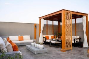 a patio with a couch and a gazebo at VELORA Serviced Rooftop Studio With Private Jacuzzi in Sodic New cairo in New cairo
