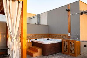 a bathroom with a large tub and a sink at VELORA Serviced Rooftop Studio With Private Jacuzzi in Sodic New cairo in New cairo +23 photos