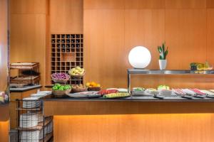 a buffet with many plates of food on a table at Hotel SB Ciutat Tarragona in Tarragona +28 photos