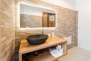 a bathroom with a black sink and a mirror at 7th Floor - Donoratico in Cagliari