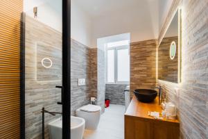 a bathroom with a toilet and a sink at 7th Floor - Donoratico in Cagliari +12 photos