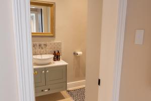 a bathroom with a sink and a mirror at Hoof House in Riebeek-Kasteel +32 photos