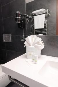 a bathroom with a sink with two glasses on it at Hotel Restaurant Darwin in Prague +57 photos